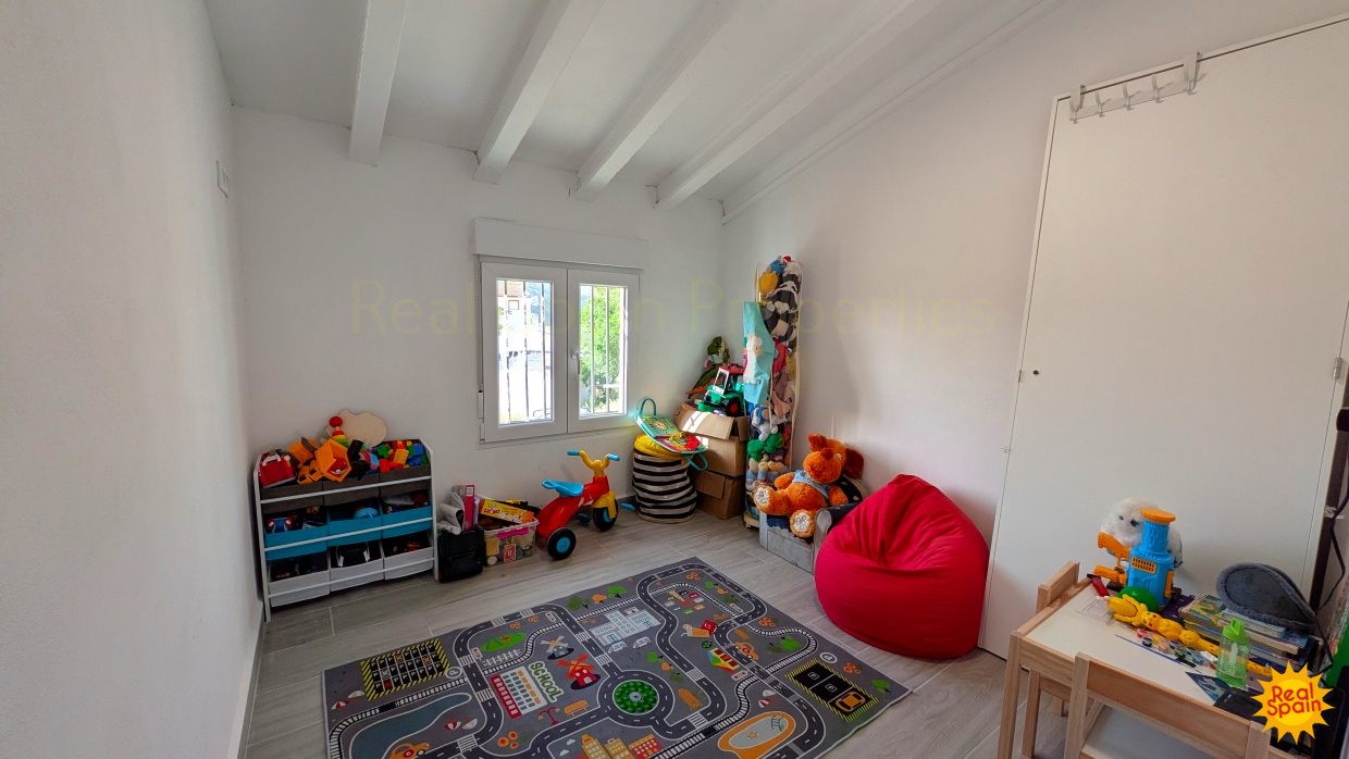 Family room or bedroom space at Cortijo Salud with toys and soft seating